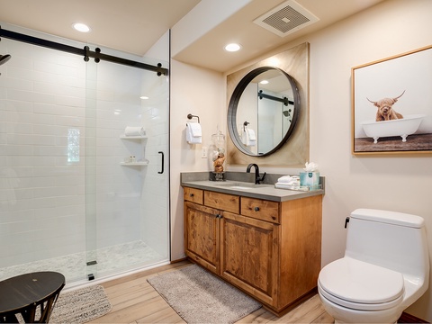 Freshen up in your stylish bathroom, where a spacious walk-in shower, modern fixtures, and warm wood vanity create your private spa retreat.