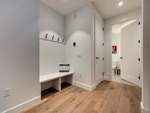 You'll find a thoughtful mudroom just beyond the entrance—clean, bright, and ready to welcome you home. Hang your gear on the wall hooks, stash shoes beneath the built-in bench, and step into mountain living with ease.