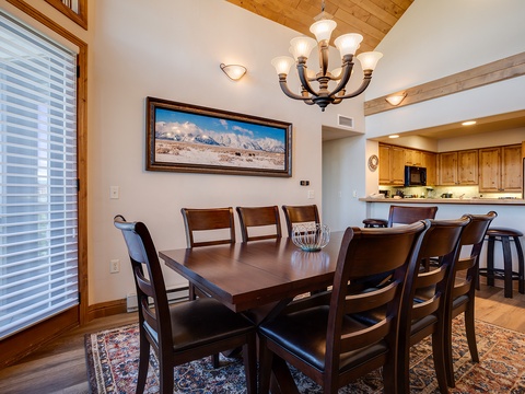 Gather around this generous dining table where mountain views and warm wood tones set the scene for your shared meals and stories throughout your stay.