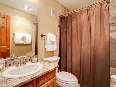 Refresh after your adventures in this well-appointed bathroom with granite counters, plush towels, and a spacious tiled shower ready for you.