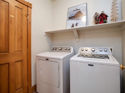 This dedicated laundry room features a full-sized washer and dryer with convenient shelving above, making it easy for you to keep your vacation wardrobe fresh throughout your stay.