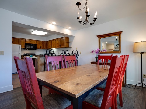Gather around the beautiful wooden table for hearty meals and laughter. This inviting dining space flows seamlessly into your fully-equipped kitchen, perfect for making memories over home-cooked dinners.