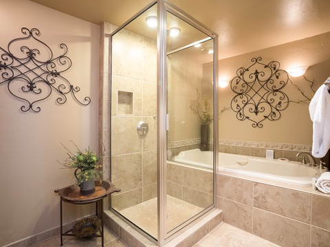 Step into your serene private spa, where warm tones and elegant décor invite you to unwind. Enjoy a refreshing rinse in your spacious walk-in shower or soak your cares away in the inviting tub.