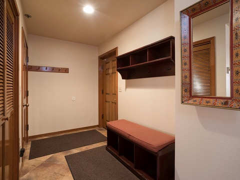 Step into your private entryway with custom storage bench and built-in shelving—perfectly designed for settling in after a day of mountain adventures.