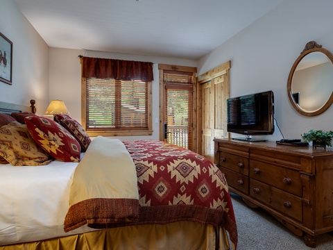 Drift off in this cozy mountain-inspired bedroom, where rustic Southwestern bedding and warm wooden accents create your perfect retreat after a day of adventure.