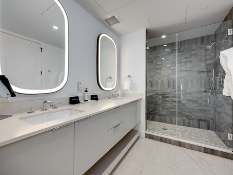 Unwind in your spa-inspired retreat with dual vanities, backlit mirrors, and a spacious walk-in shower designed for relaxation.