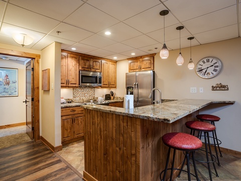 Your fully equipped kitchen invites you to cook and gather around the granite breakfast bar, perfect for morning coffee or casual meals with friends and family.