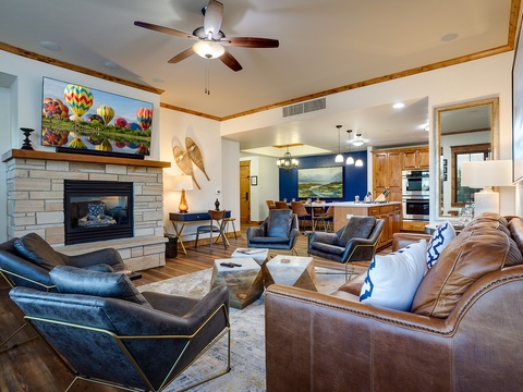 Gather with loved ones in this spacious living area featuring a cozy fireplace, plush leather seating, and warm wood accents that invite you to relax and feel right at home.