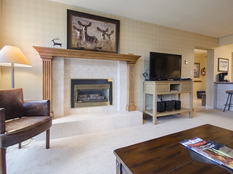 Gather by your private fireplace for cozy evenings, enjoying the warm glow and mountain-inspired decor that makes this living room feel like home.
