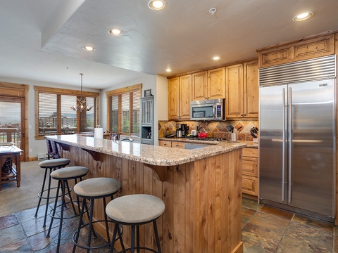 Your fully-equipped kitchen invites easy meal prep, with granite countertops, stainless steel appliances, and a spacious island for gathering over morning coffee or evening appetizers.