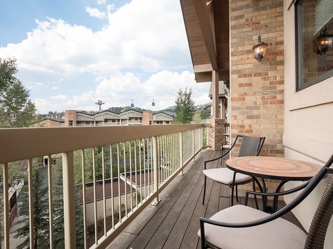 This view overlooks a residential neighborhood with nearby buildings and hillside greenery, offering context for the property's setting and surrounding area.