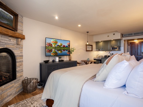Sink into plush bedding and enjoy cozy evenings by your own fireplace, with a full kitchen and entertainment at your fingertips in this thoughtfully designed retreat.