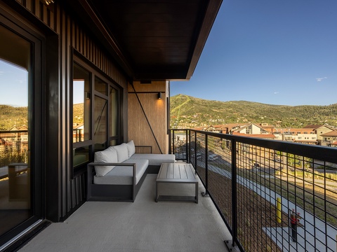 Step onto your private balcony and soak in stunning mountain views—your perfect spot for morning coffee or unwinding as the sun sets over the hillside town below.