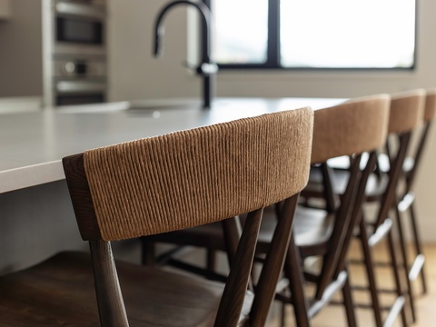 Pull up a seat at the sleek breakfast bar, where morning coffee and casual meals come naturally. Soft light and modern design set the tone for easy, comfortable living.