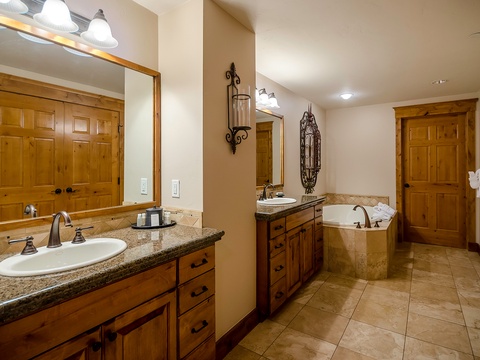 Unwind in your spacious bathroom with dual vanities, elegant granite countertops, and a luxurious soaking tub—perfect for melting away the day after mountain adventures.