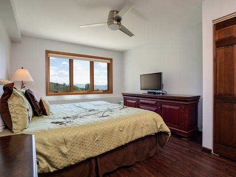 Wake up to stunning mountain and water views framing your peaceful retreat. Relax in comfort with tasteful furnishings, a ceiling fan, and your own entertainment space.