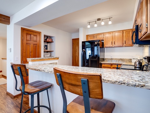 Your private kitchen features granite countertops, stainless appliances, and a welcoming breakfast bar—perfect for morning coffee or preparing hearty meals after a day of adventure.