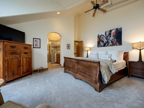 Sink into your peaceful bedroom retreat, with a plush bed, warm wood furnishings, and soft lighting that creates the perfect atmosphere for restful nights.