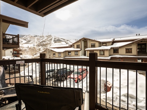 A snow-dusted balcony frames sweeping mountain views and surrounding alpine village, offering an inviting outdoor retreat at this ski-accessible retreat.