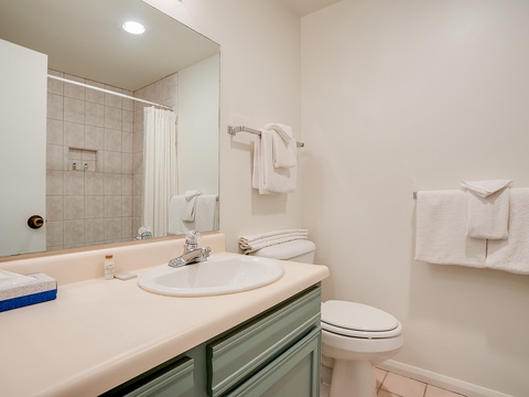 Your private bathroom features fresh towels, a walk-in shower, and plenty of counter space to settle in and feel at home during your stay.