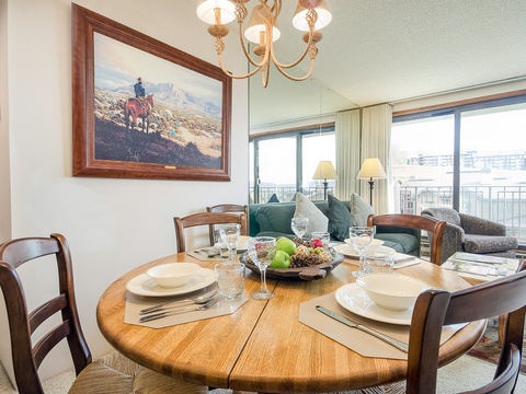 Gather around this inviting dining table for meals with family or friends, where you can enjoy waterfront views through expansive windows as you dine in comfort and style.