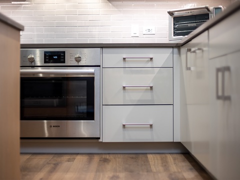 A sleek, modern kitchen with stainless steel appliances and crisp white cabinetry, ready for you to prepare meals during your stay.