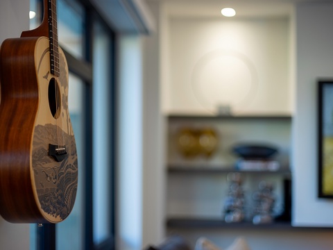 A beautifully crafted guitar awaits your next melody, adding artistic character and inviting spontaneous music moments during your stay.