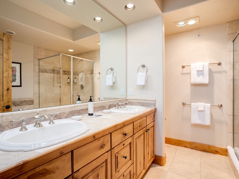 Your private bathroom features double vanities, fresh towels, and a spacious walk-in shower—perfectly designed for a relaxing start to your mountain mornings.