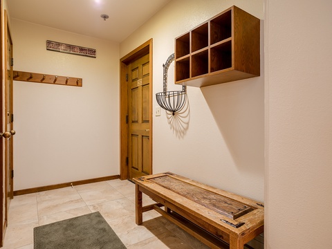 Step into your welcoming entryway with warm wood accents, a rustic bench for your gear, and thoughtful storage cubbies to help you settle right in.