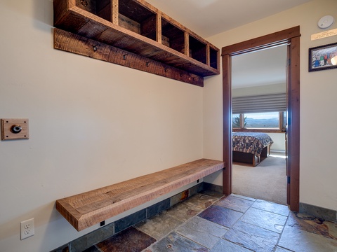 Unpack in your private entryway with custom wood storage and bench seating, then step into your bedroom with mountain views framing your window.