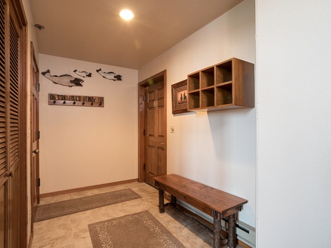 Step into your welcoming entryway with warm wood accents, a cozy bench, and coastal-inspired decor—perfect for storing your gear after a day of adventure.