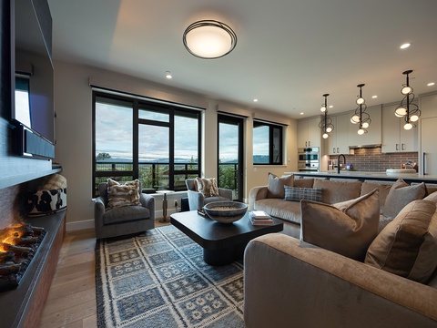 Sink into plush sofas by the fireplace and let the stunning landscape views through floor-to-ceiling windows become your favorite daily backdrop.