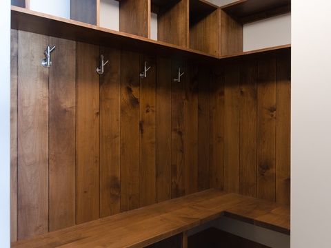 Your mudroom awaits with rustic wood paneling, sleek hooks for coats and bags, and built-in storage above to keep your belongings organized and accessible throughout your stay.