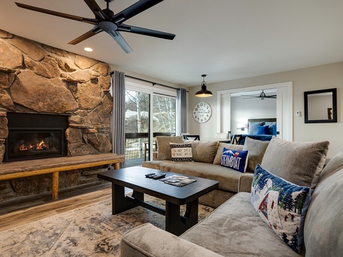 Unwind in your spacious living room with a stone fireplace, plush seating, and mountain views—perfect for cozy evenings after a day exploring Colorado.