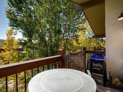 Perched above vibrant autumn foliage, this private balcony offers a peaceful treetop retreat where you can enjoy morning coffee or evening relaxation surrounded by nature's seasonal beauty.