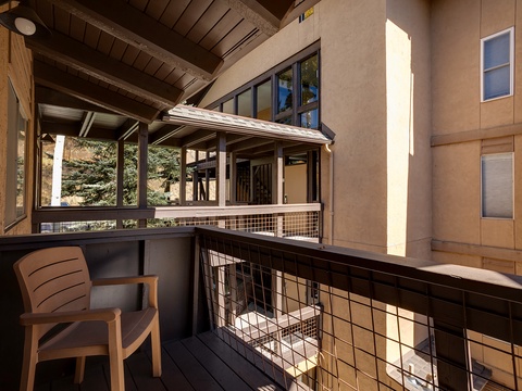 Exterior view of a modern mountain property with contemporary architecture, exposed beams, and multi-level design surrounded by evergreen trees.