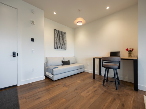 Settle in to your bright, modern space with a cozy sofa and thoughtful workspace—perfect for unwinding or catching up on a few emails before heading out to explore.