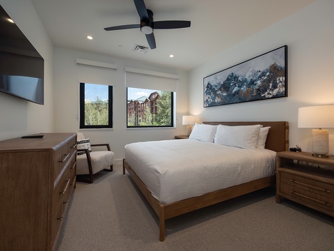 Sink into crisp linens and wake up to sunshine streaming through your windows. Your plush bed invites restful sleep, while modern wood furnishings and a ceiling fan ensure comfort throughout your stay.