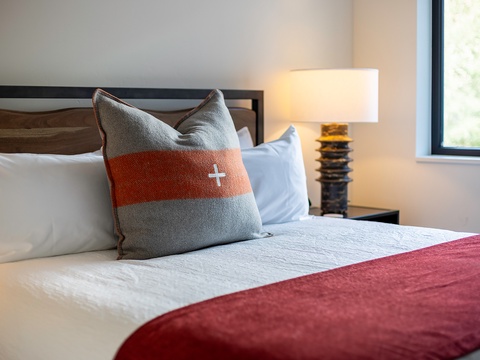 Sink into plush bedding and soft pillows after a day of adventure. Natural light fills your peaceful retreat, setting the stage for restful nights.