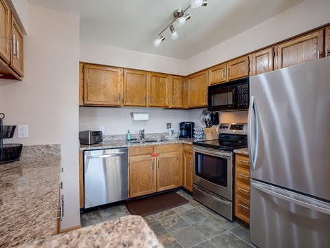 Your fully equipped kitchen features stainless steel appliances, granite countertops, and rich oak cabinetry—everything you need to whip up a meal or brew your morning coffee in comfort.