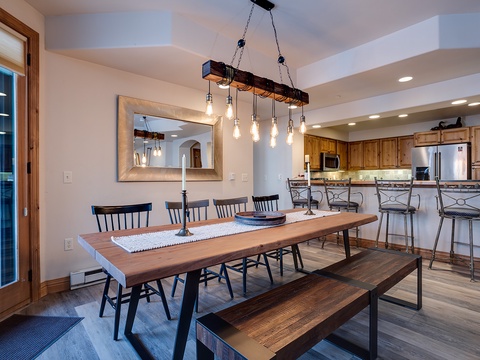 Gather around this beautiful farmhouse table under rustic Edison lighting, with open-plan kitchen and bar seating creating the perfect space for your group meals and conversations.