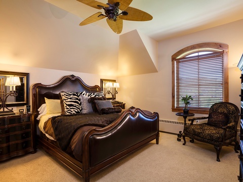 Sink into plush bedding under vaulted ceilings, where a tropical fan keeps you cool. Elegant furniture and soft lighting create your perfect retreat after a day exploring.
