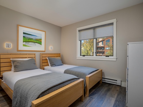 Sink into crisp, comfortable twin beds after a day of exploring—your peaceful retreat features natural light and serene tones for a restful night's sleep.