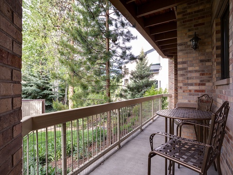 Picture yourself sipping morning coffee on your private covered balcony, surrounded by tall pines and peaceful greenery. This cozy outdoor retreat is perfect for unwinding after a day of adventure.