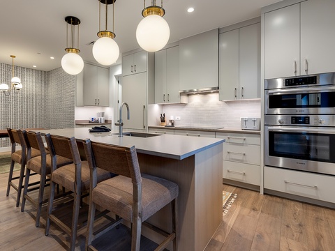 Gather around the sleek kitchen island where modern meets comfort. With gleaming appliances, soft pendant lighting, and plenty of counter space, you'll love preparing meals together here.