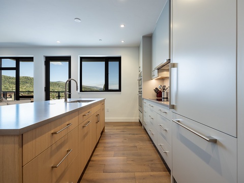Step into your modern, light-filled kitchen with sleek cabinetry, ample counter space, and sweeping mountain views—your perfect spot to create and gather.