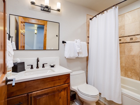 Step into your private bathroom with warm wood finishes, elegant tilework, and fresh towels waiting just for you. Everything you need to unwind after a day of mountain adventures.