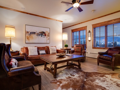 Picture yourself unwinding in this warm, elegantly appointed living room, where rich leather seating and charming rustic touches create the perfect retreat after a day exploring the mountains.