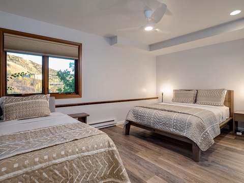 Your spacious bedroom offers two comfortable beds with soft linens, warm bedside lighting, and a scenic mountain view to wake up to each morning.