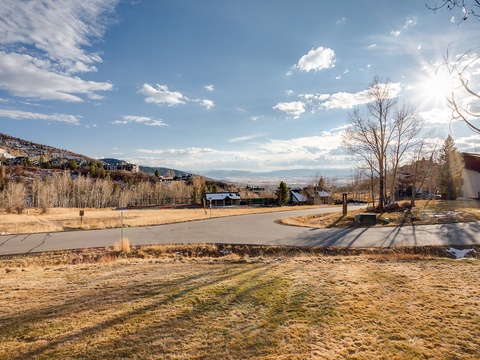 A serene mountain neighborhood with sweeping valley views and quiet residential streets, surrounded by natural beauty and nearby slopes.